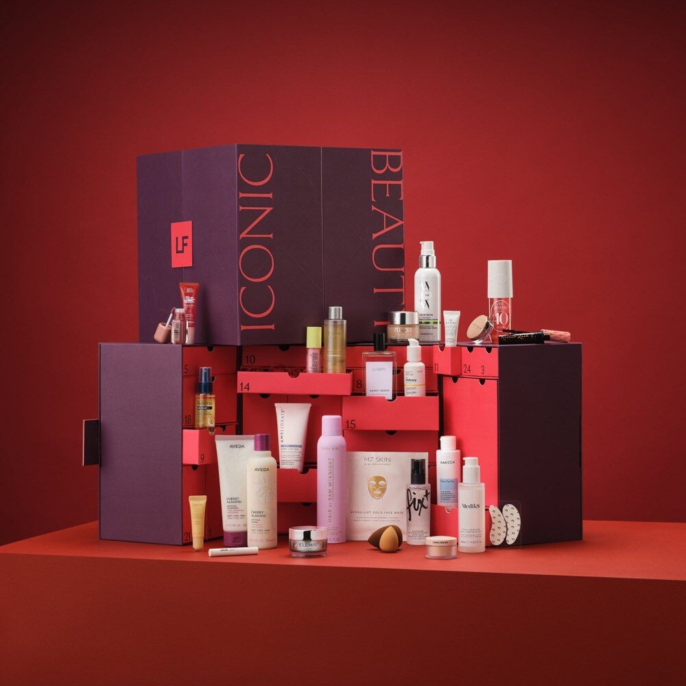 Le calendrier de l’Avent Lookfantastic 2026 violet et rouge, entouré des produits de beauté qu’il contient